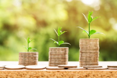 Upsplash image of stack of ascending coins and new plant shoots